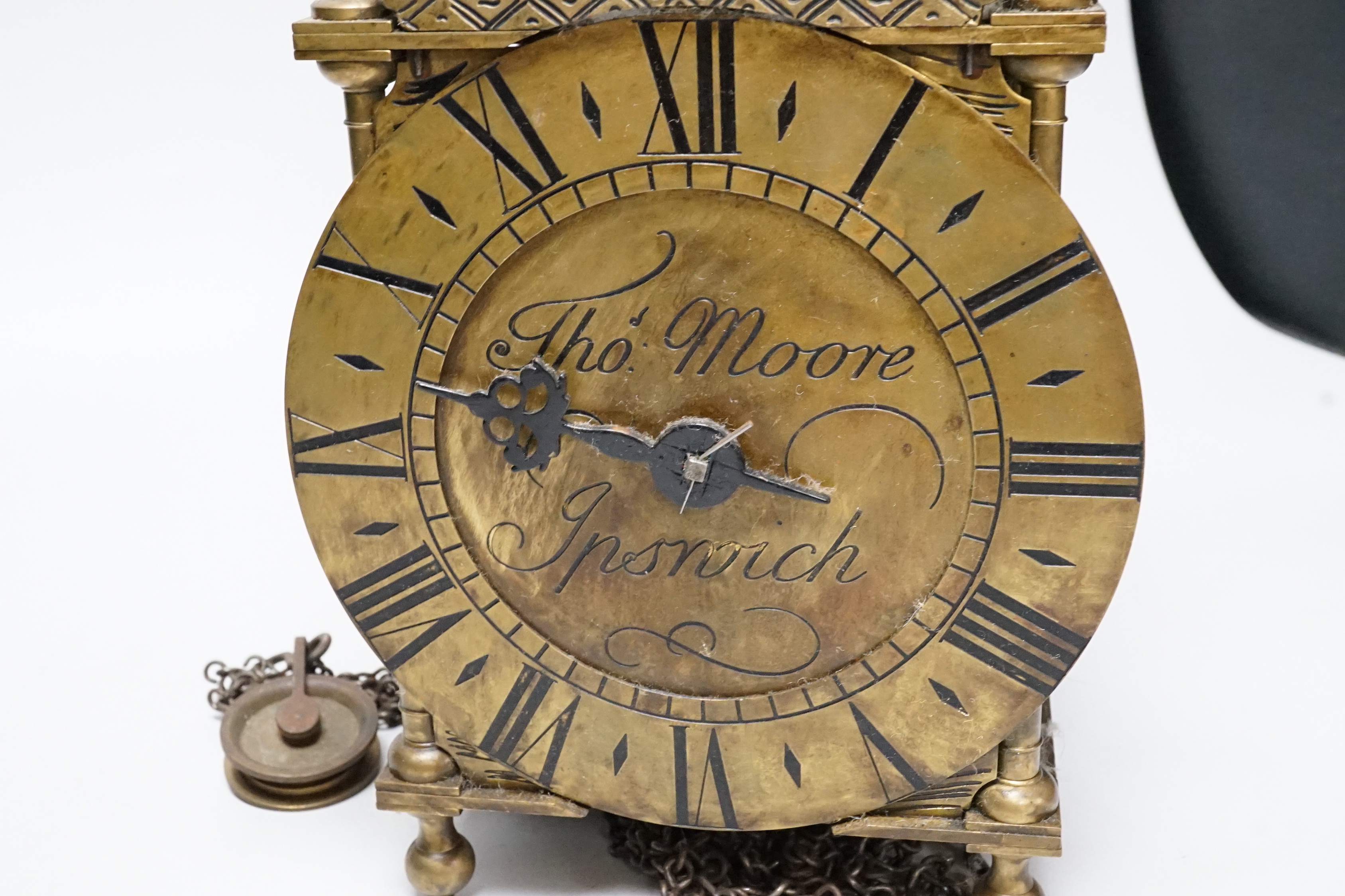 An English brass lantern clock with four branch finial decoration signed Tho Moore of Ipswich, 36cm tall